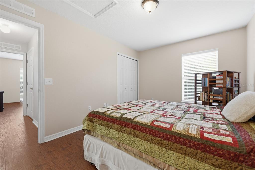 23152 Northwest 11th Road Newberry, FL 32669 - Photo 21 of 31 a bedroom with a bed and wooden floor