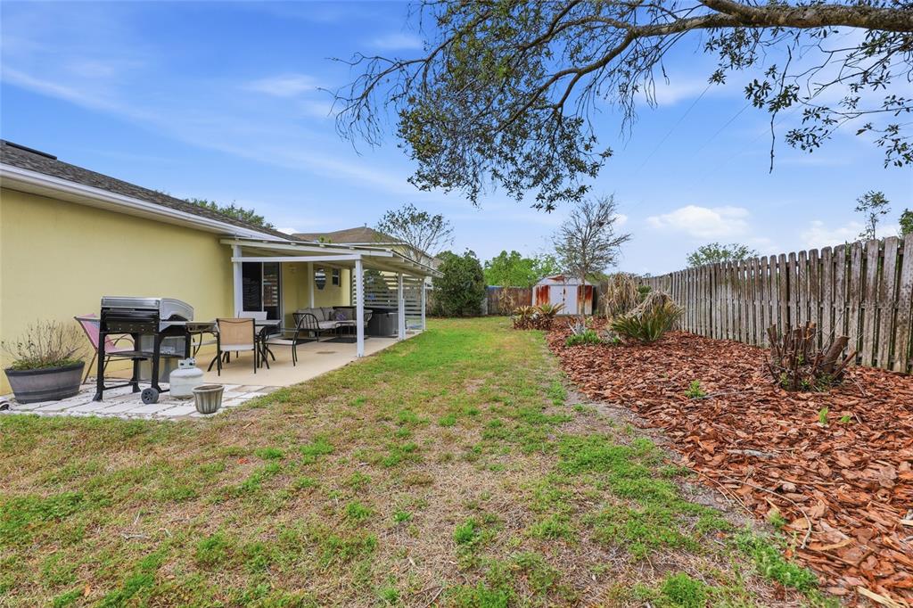 23152 Northwest 11th Road Newberry, FL 32669 - Photo 27 of 31 a view of house with backyard and seating area