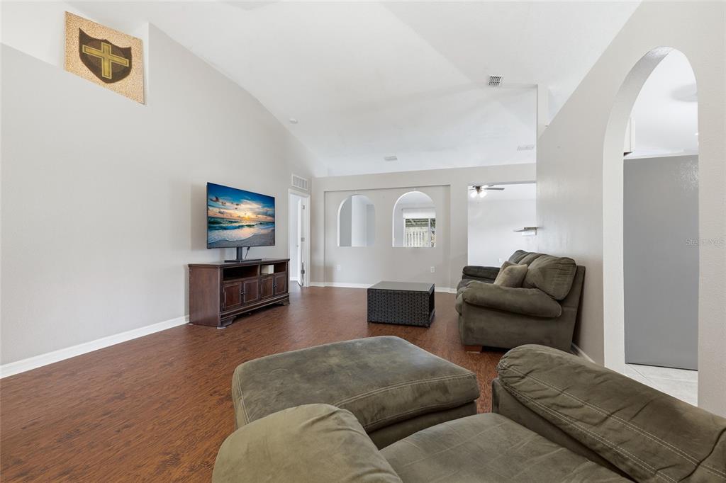 23152 Northwest 11th Road Newberry, FL 32669 - Photo 6 of 31 a living room with furniture and a flat screen tv