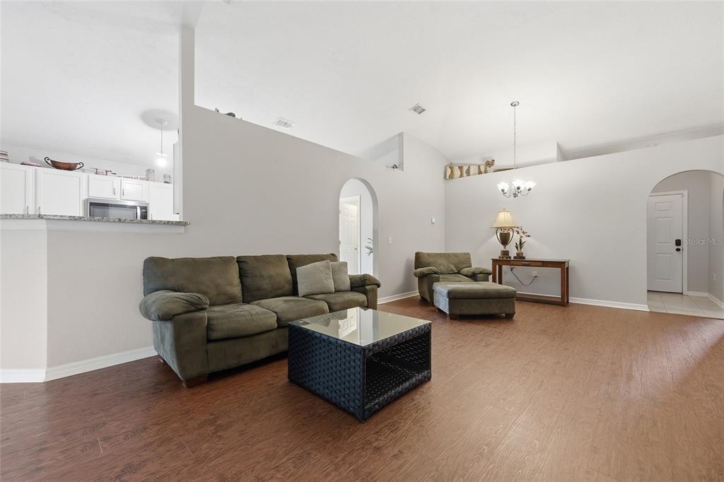 23152 Northwest 11th Road Newberry, FL 32669 - Photo 7 of 31 a living room with furniture and kitchen view