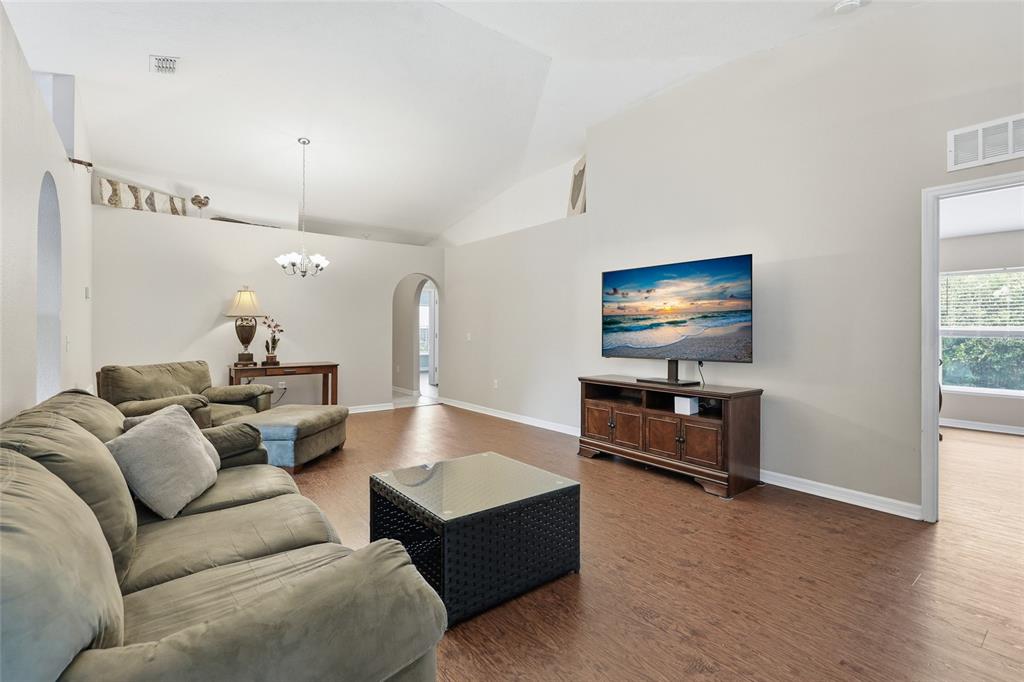 23152 Northwest 11th Road Newberry, FL 32669 - Photo 8 of 31 a living room with furniture and a flat screen tv