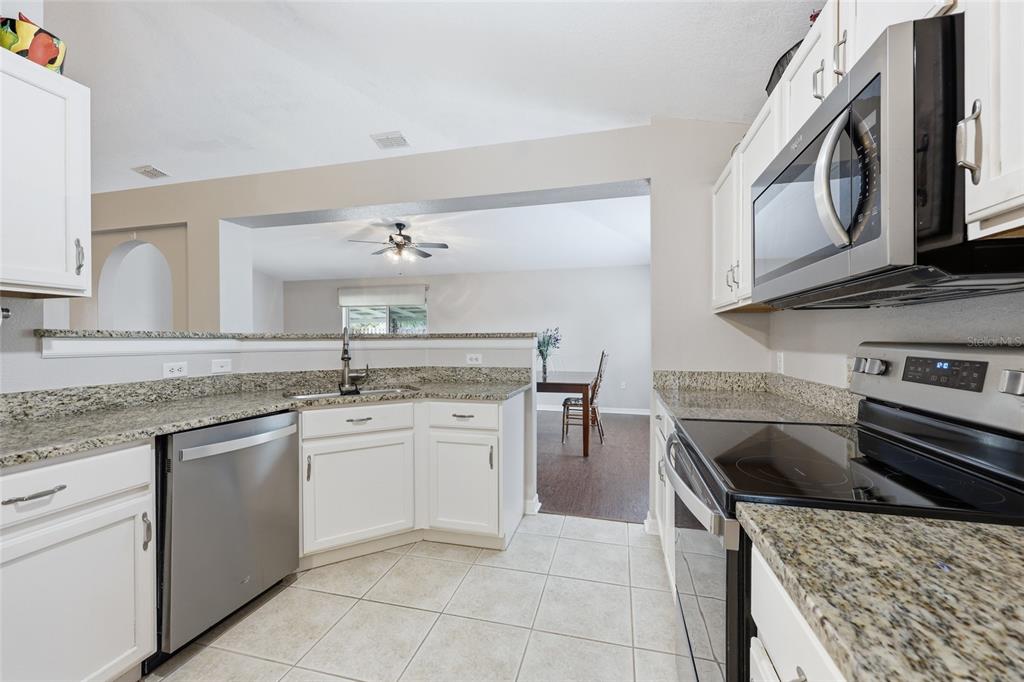 23152 Northwest 11th Road Newberry, FL 32669 - Photo 10 of 31 a kitchen with a stove sink and cabinets