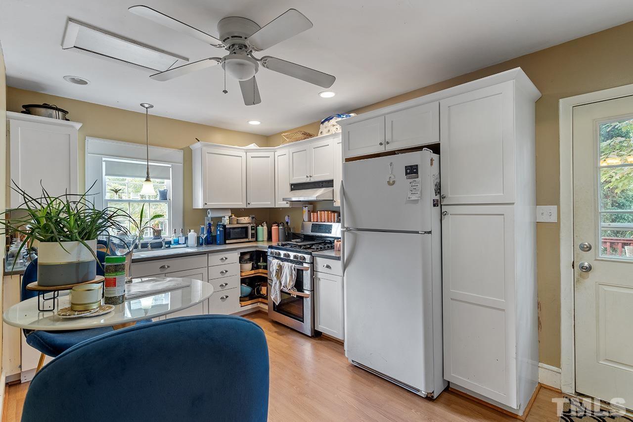 324 Cutler Street Raleigh, NC 27603 - Photo 12 of 34 a kitchen with refrigerator a sink and cabinets