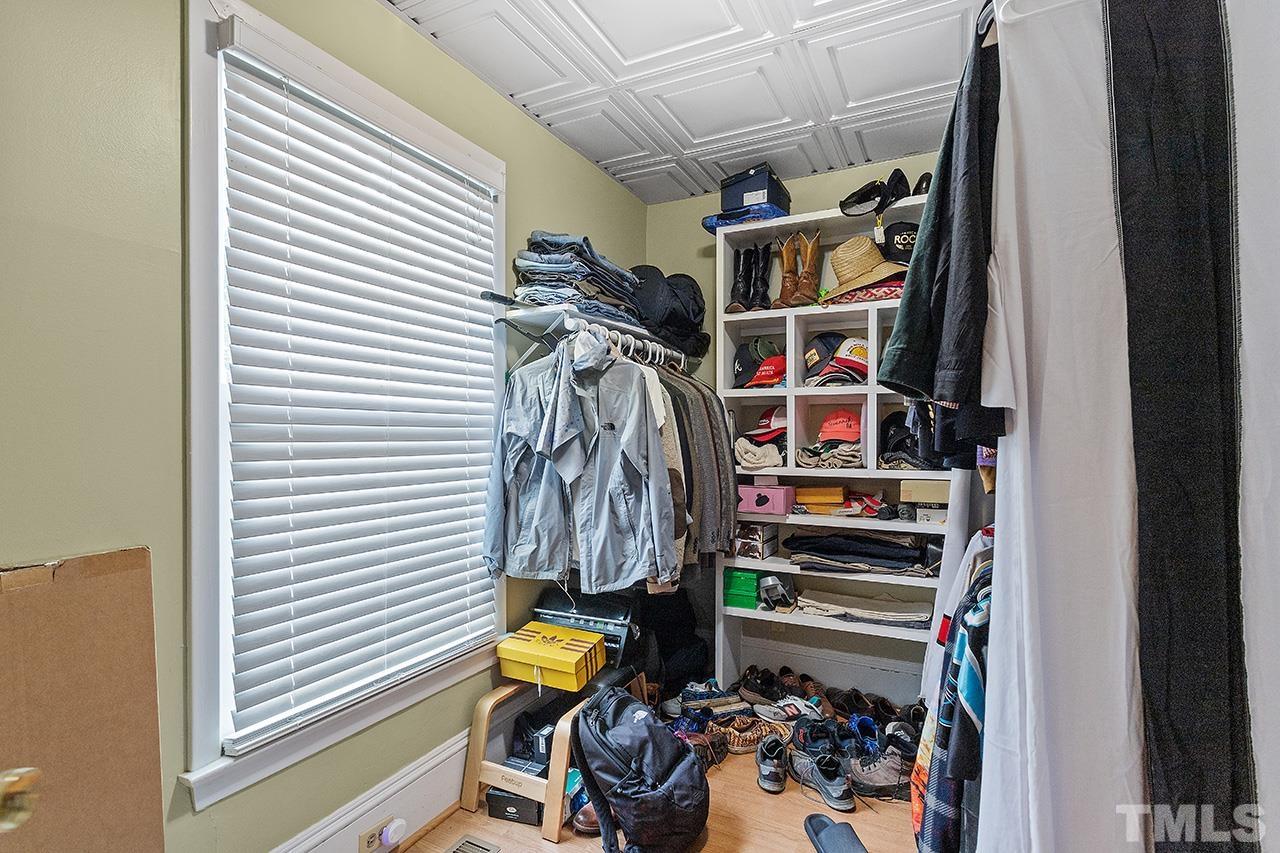 324 Cutler Street Raleigh, NC 27603 - Photo 17 of 34 a view of walk in closet with clothes and shoes