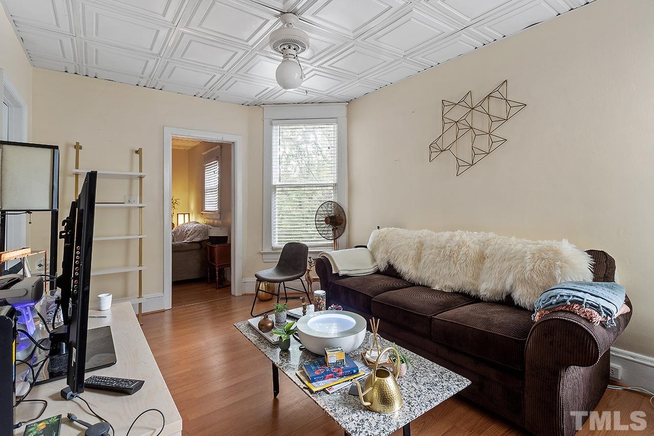 324 Cutler Street Raleigh, NC 27603 - Photo 18 of 34 a living room with furniture and a chandelier