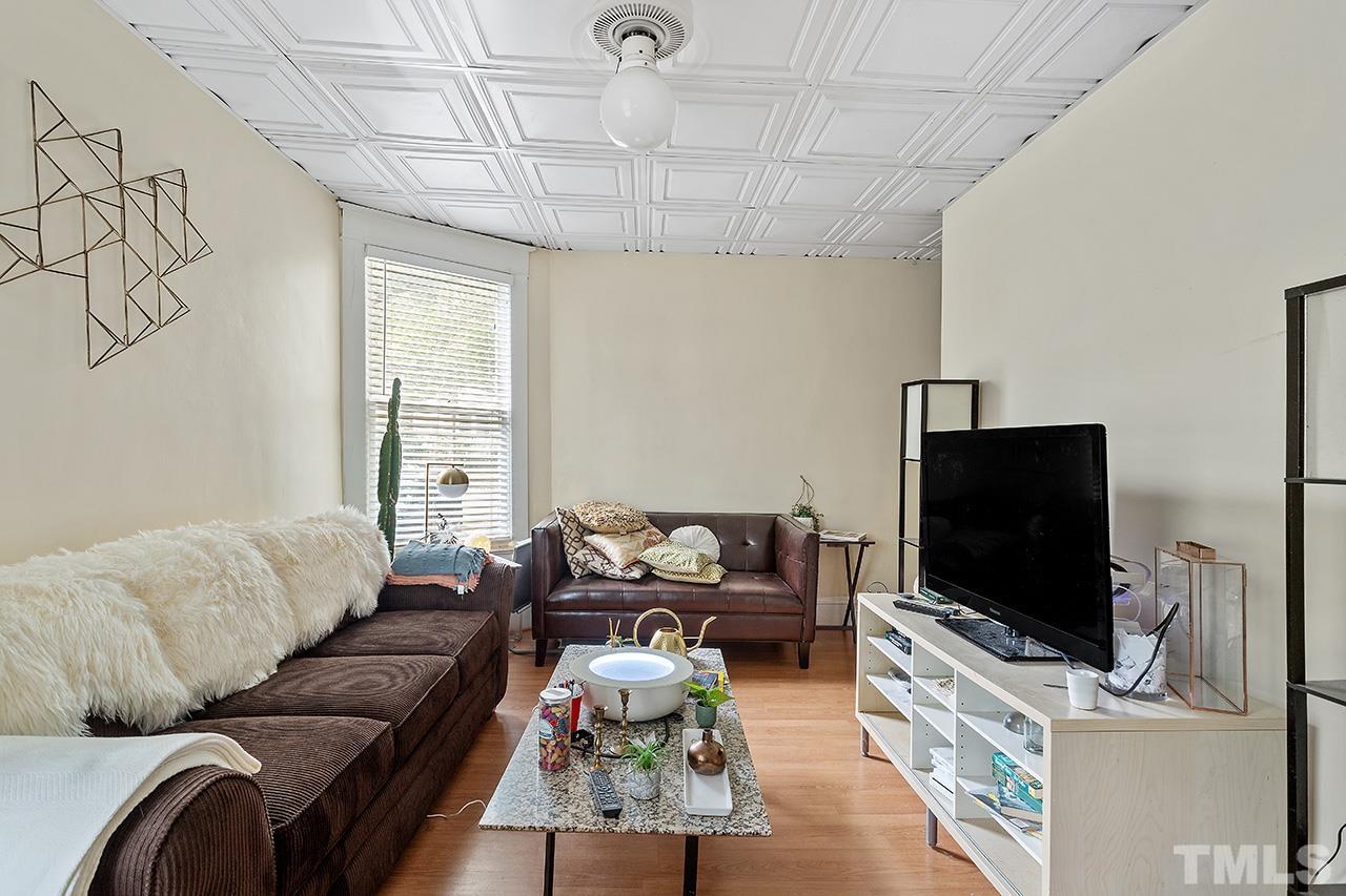 324 Cutler Street Raleigh, NC 27603 - Photo 20 of 34 a living room with furniture and a flat screen tv