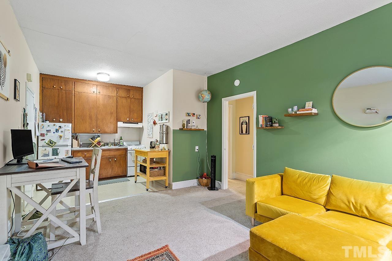 324 Cutler Street Raleigh, NC 27603 - Photo 22 of 34 a living room with furniture a fireplace and a flat screen tv