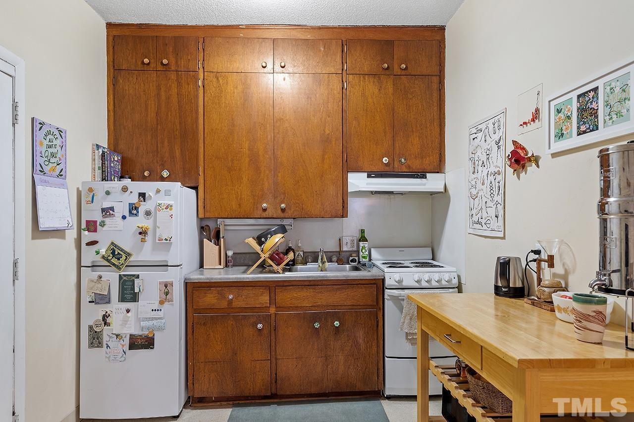 324 Cutler Street Raleigh, NC 27603 - Photo 24 of 34 a kitchen with a refrigerator and a stove