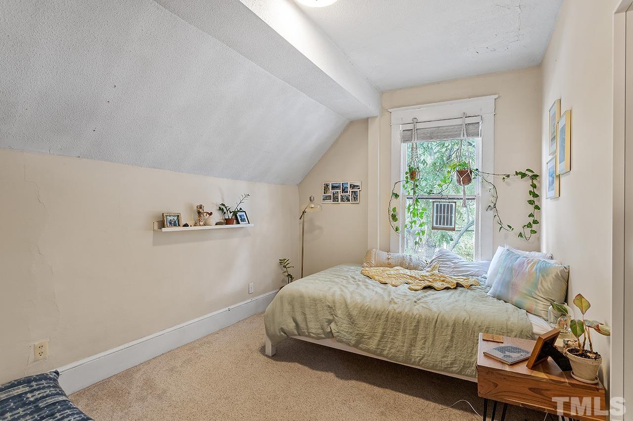 324 Cutler Street Raleigh, NC 27603 - Photo 25 of 34 a bedroom with a bed and a window
