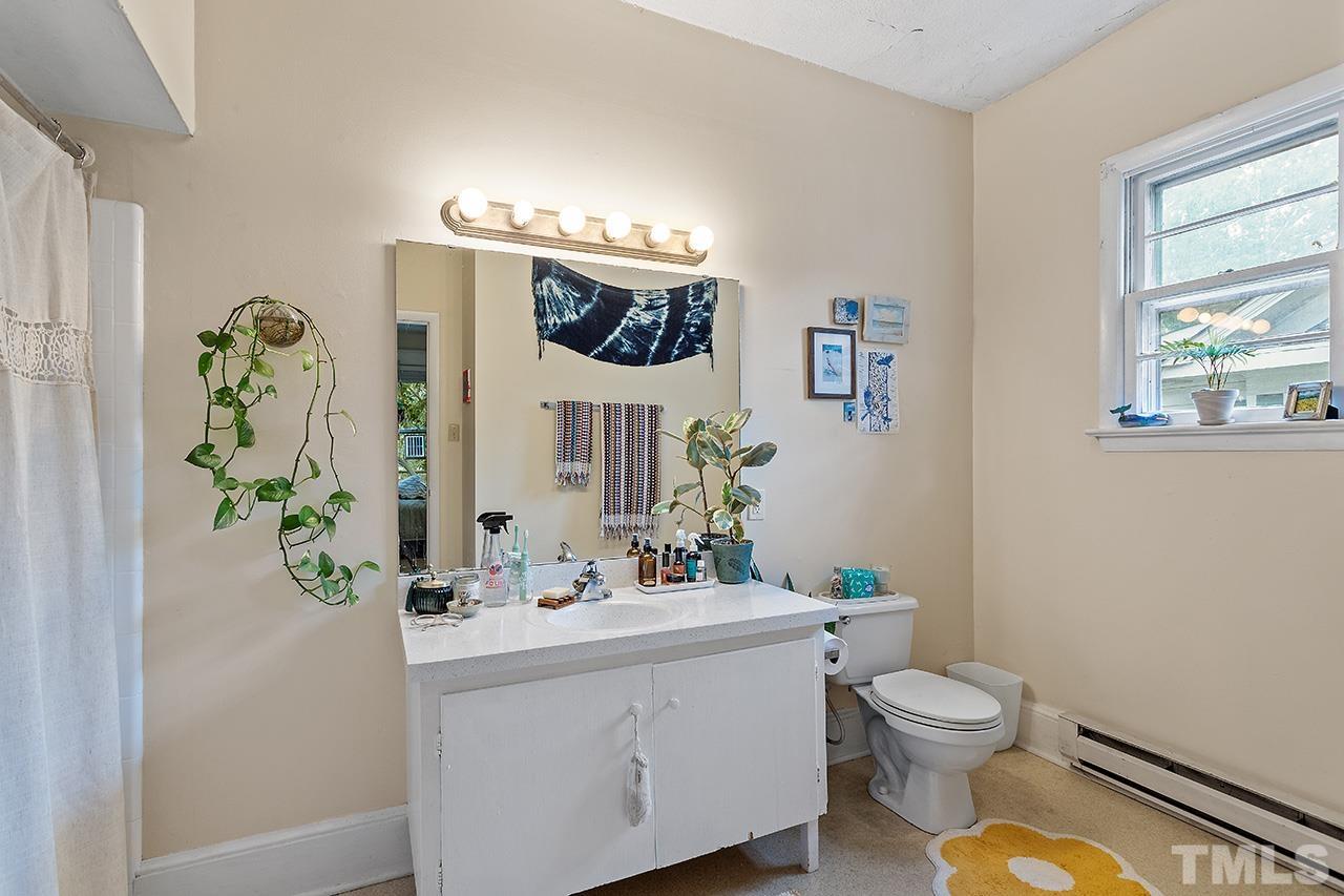 324 Cutler Street Raleigh, NC 27603 - Photo 26 of 34 a bathroom with a sink a mirror and a toilet