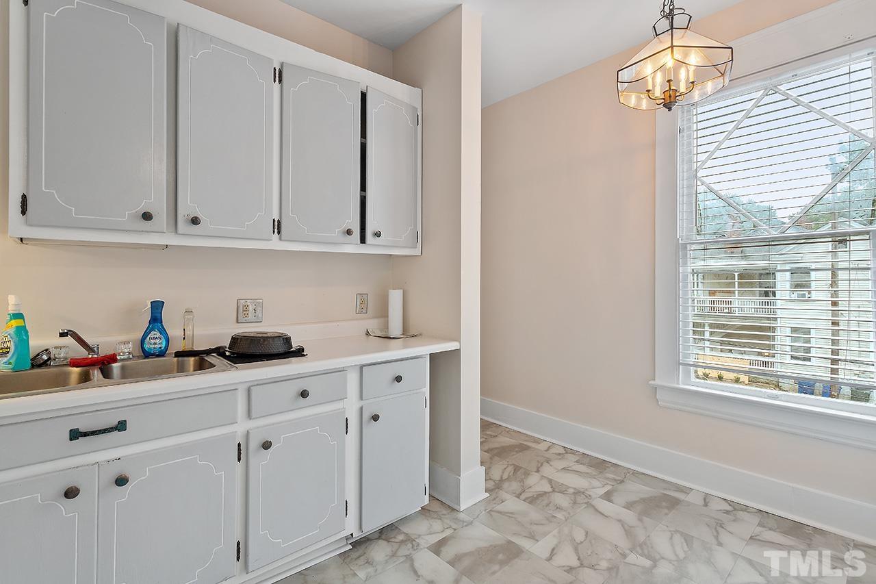 324 Cutler Street Raleigh, NC 27603 - Photo 28 of 34 a kitchen with white cabinets and window