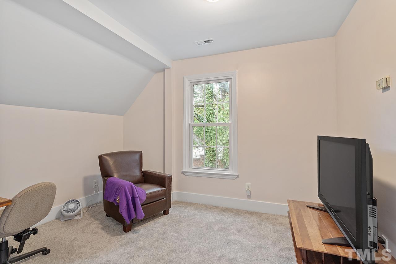 324 Cutler Street Raleigh, NC 27603 - Photo 29 of 34 a living room with furniture a window and a flat screen tv