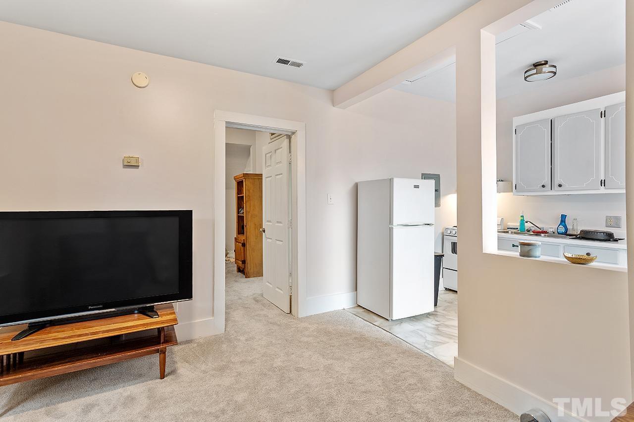 324 Cutler Street Raleigh, NC 27603 - Photo 30 of 34 a living room with furniture and a flat screen tv