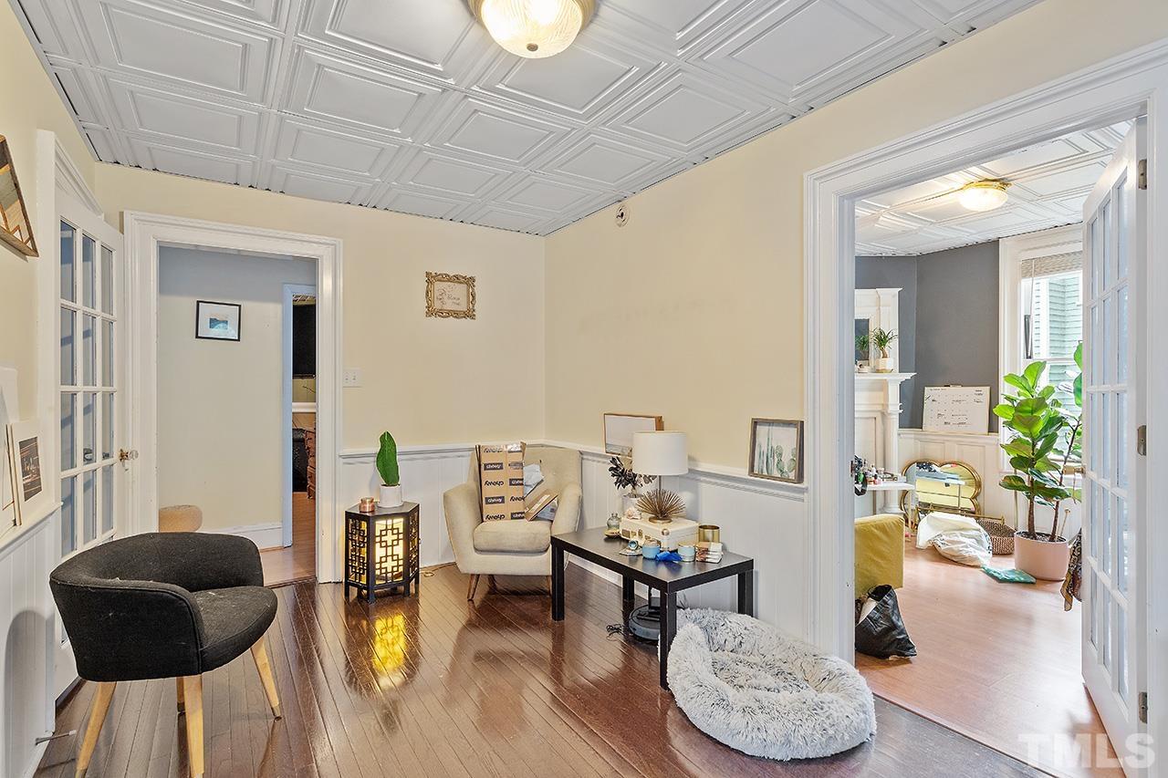 324 Cutler Street Raleigh, NC 27603 - Photo 33 of 34 a living room with furniture and a wooden floor