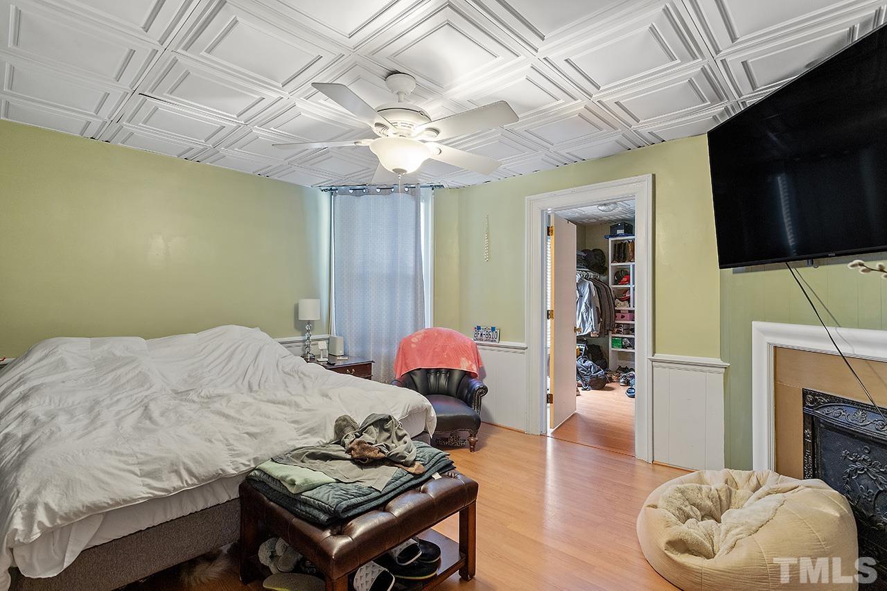 324 Cutler Street Raleigh, NC 27603 - Photo 7 of 34 a bedroom with furniture and a fireplace