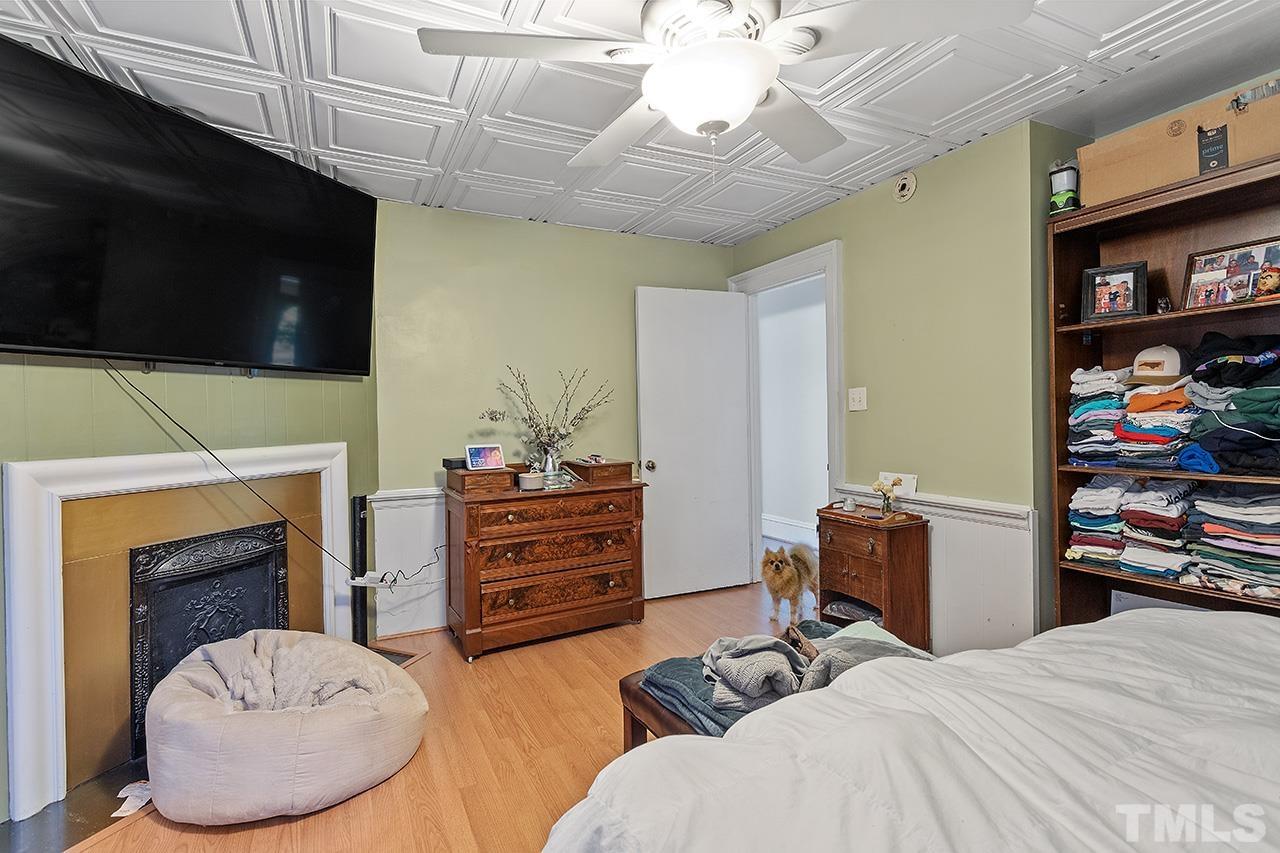 324 Cutler Street Raleigh, NC 27603 - Photo 8 of 34 a bedroom with furniture and a fireplace