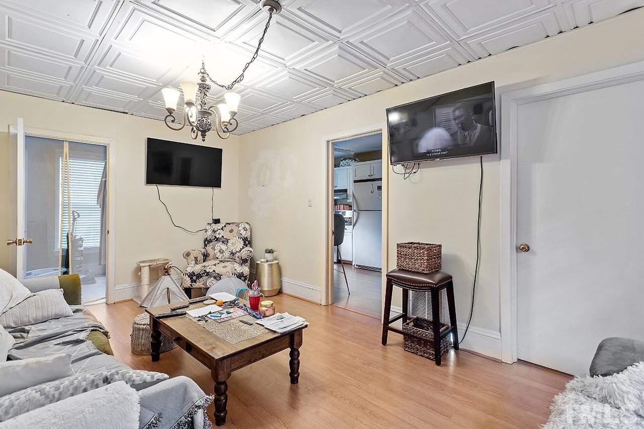 324 Cutler Street Raleigh, NC 27603 - Photo 10 of 34 a living room with furniture or chandelier and a wooden floor