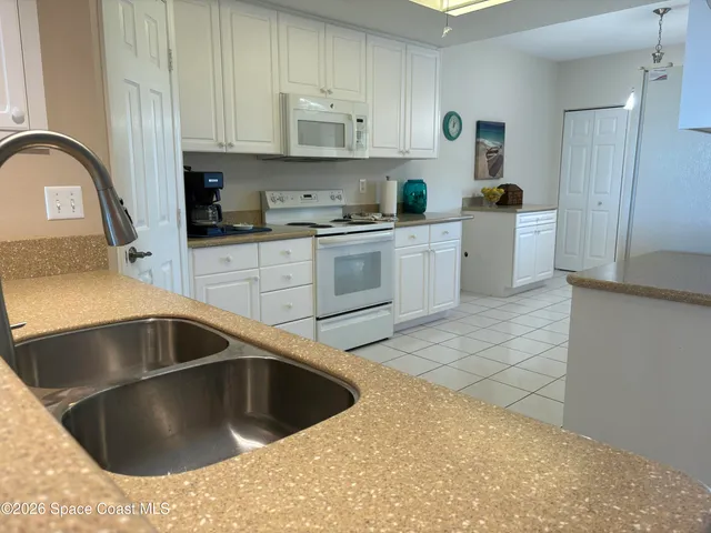 a kitchen with a sink cabinets and appliances