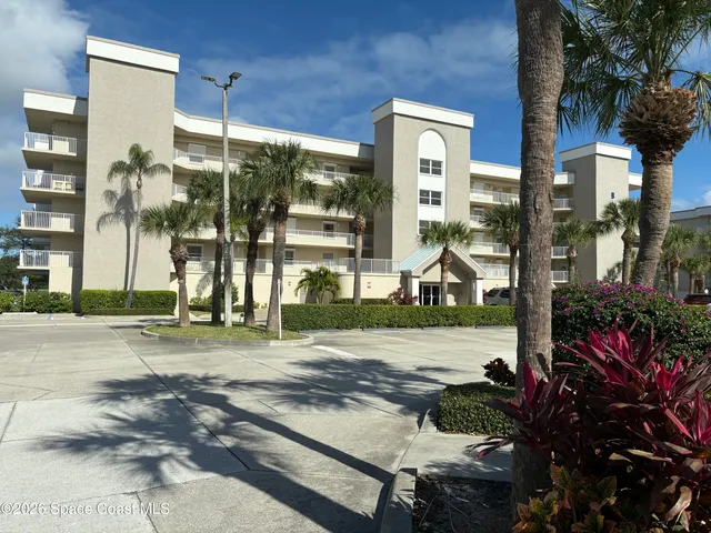 a view of a brick house with a floor to ceiling windows and a basket ball poll