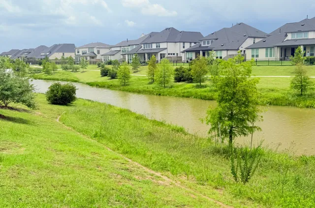 a view of a large garden with a house in the background