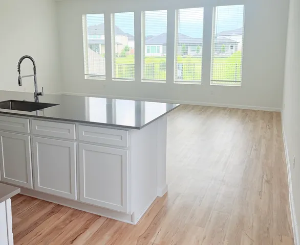 a view of a kitchen with wooden floor and staircase
