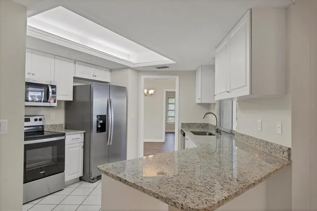 a kitchen with stainless steel appliances granite countertop a sink and cabinets
