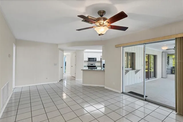 a view of a livingroom with a chandelier furniture and windows
