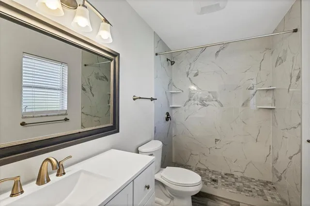 a bathroom with a sink toilet and shower