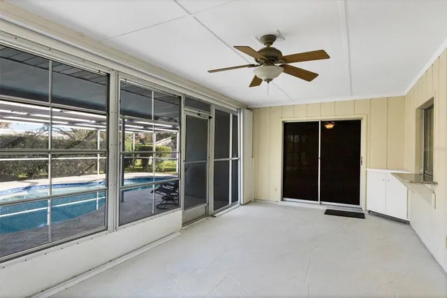 a view of empty room with cabinet and windows