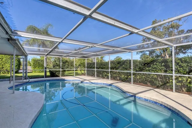a view of a backyard with a swimming pool