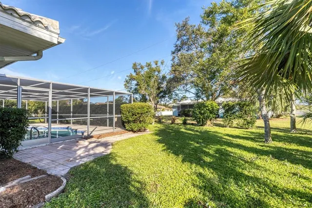 a view of a backyard with table and chairs and potted plants