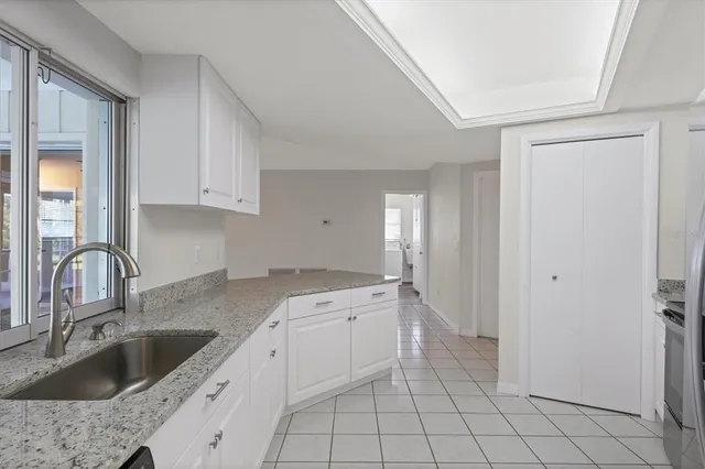 a kitchen with a sink cabinets and window