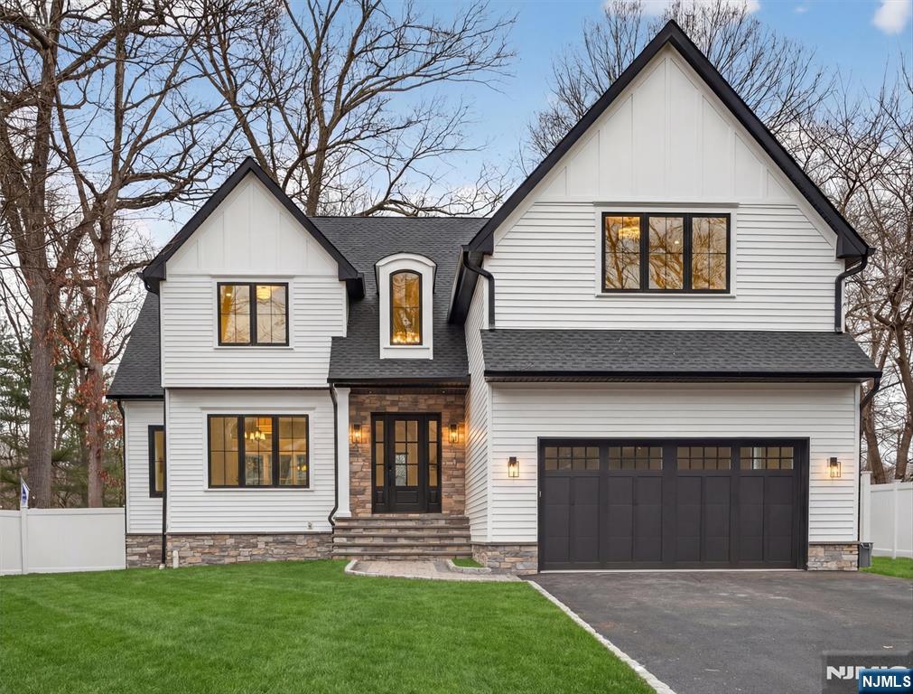 a front view of a house with a yard and garage
