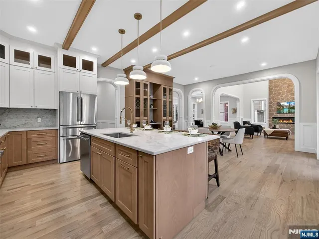 a large kitchen with stainless steel appliances lots of counter space and a sink