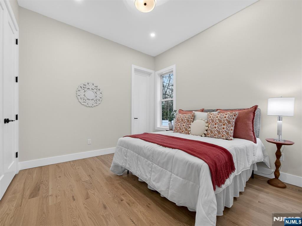 61 Beech Street Ramsey, NJ 07446 - Photo 16 of 41 a bedroom with a bed and painting on the wall