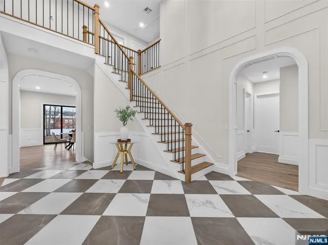 a view of a hallway with a black and white checkered floor