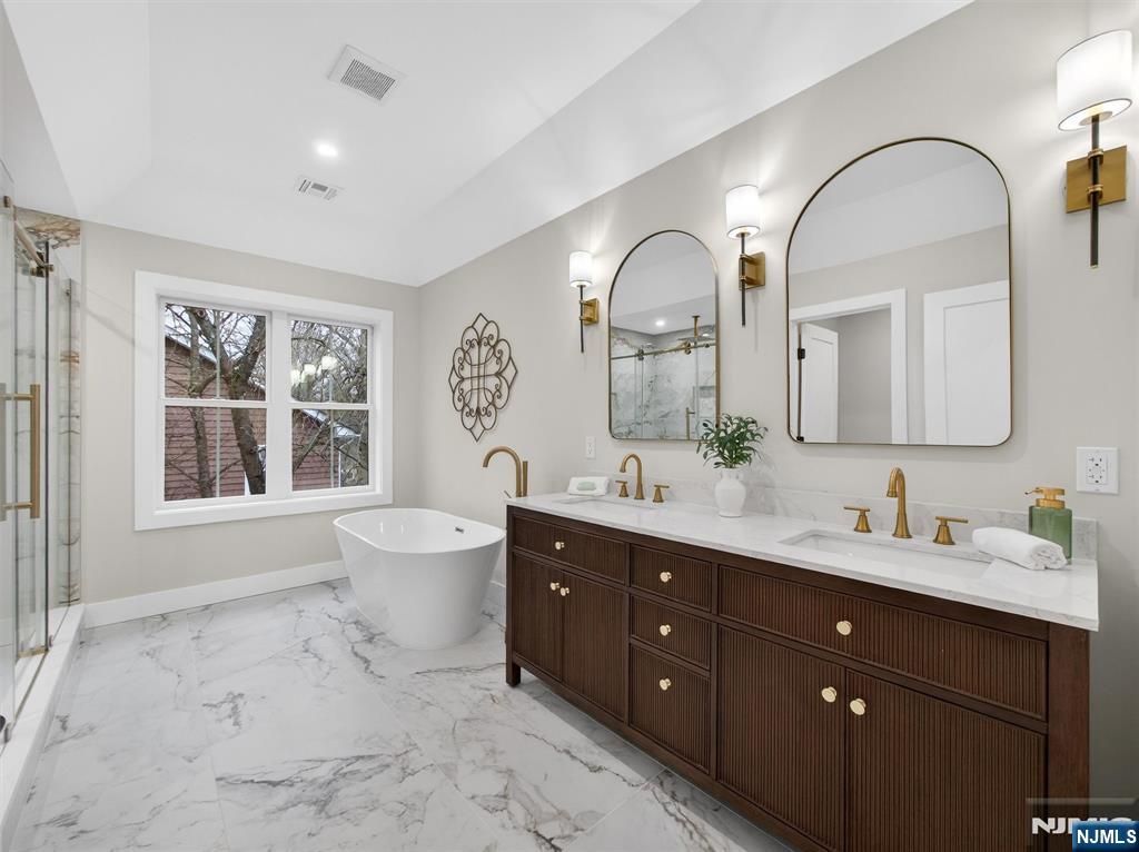 61 Beech Street Ramsey, NJ 07446 - Photo 23 of 41 a spacious bathroom with a double vanity sink toilet mirror and windows