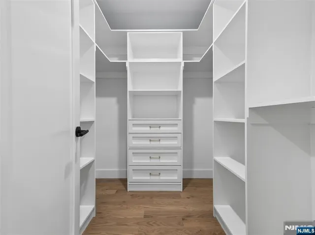 a view of walk in closet with empty racks