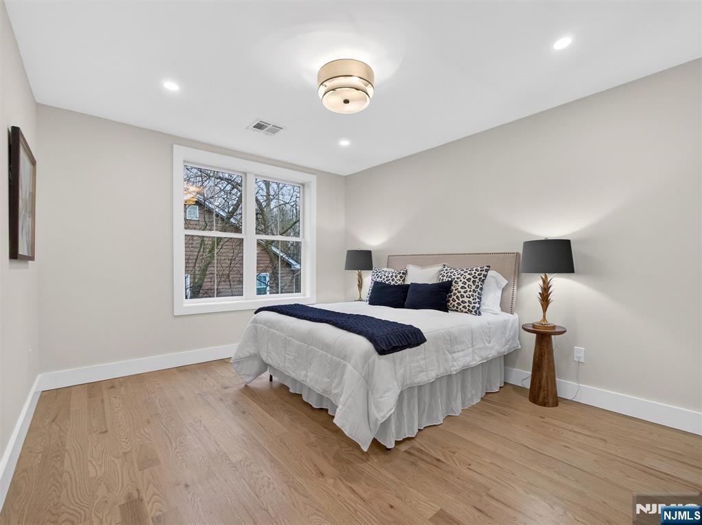 61 Beech Street Ramsey, NJ 07446 - Photo 28 of 41 a spacious bedroom with a bed and a window