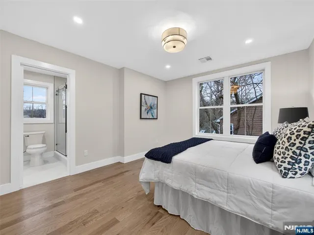 a bedroom with a large bed and a window