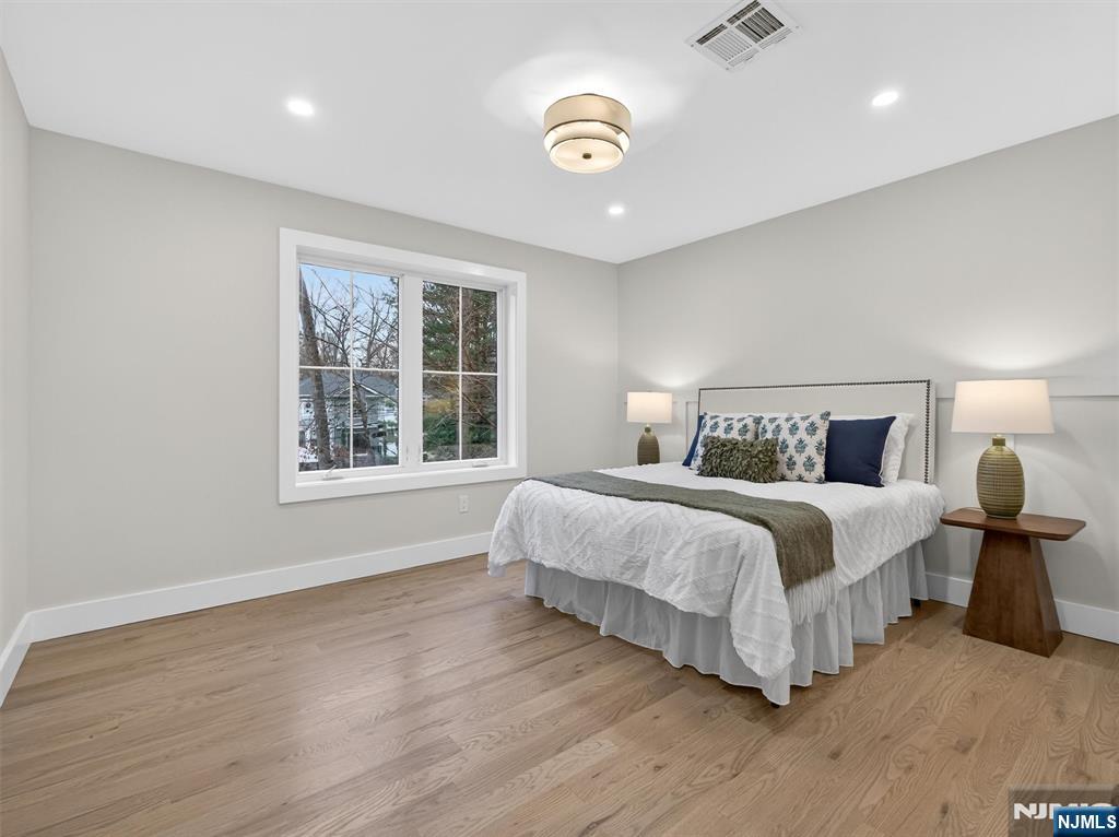 61 Beech Street Ramsey, NJ 07446 - Photo 30 of 41 a spacious bedroom with a bed and a window
