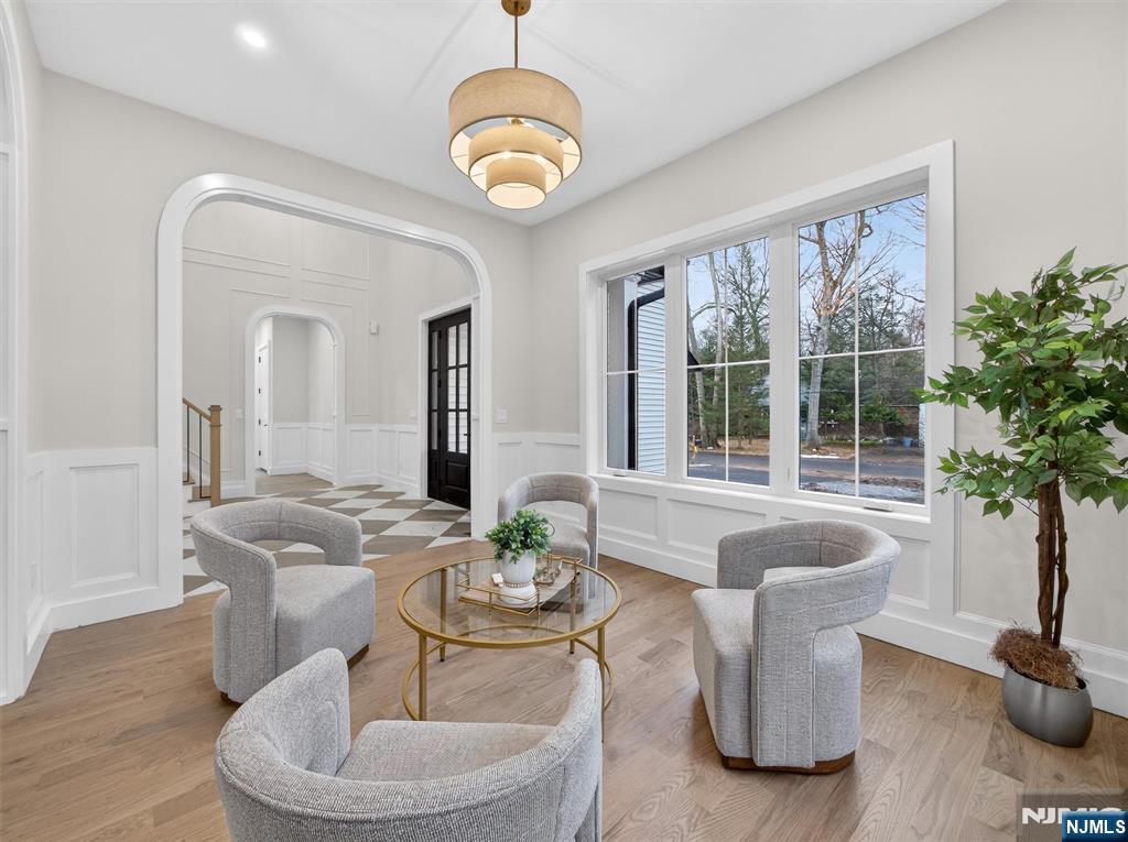 61 Beech Street Ramsey, NJ 07446 - Photo 3 of 41 a living room with furniture a potted plant and a large window