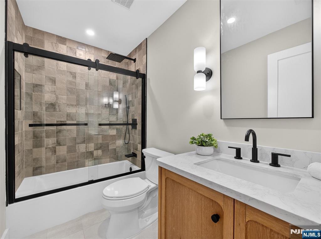 61 Beech Street Ramsey, NJ 07446 - Photo 31 of 41 a bathroom with a shower sink vanity mirror and toilet