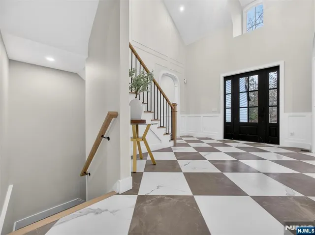 a view of a hallway with wooden floor and black white checkered floor