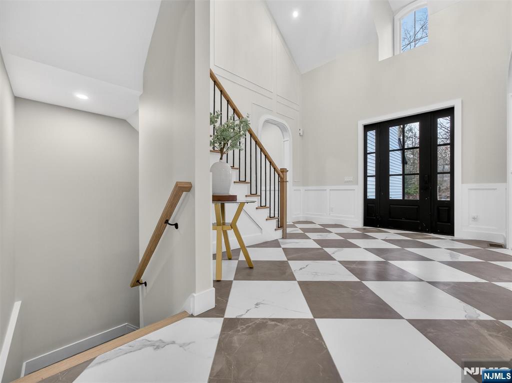 61 Beech Street Ramsey, NJ 07446 - Photo 32 of 41 a view of a hallway with wooden floor and black white checkered floor