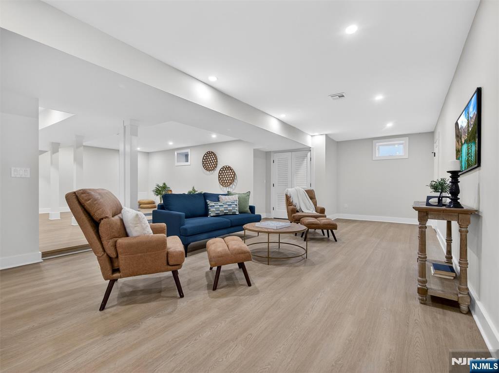 61 Beech Street Ramsey, NJ 07446 - Photo 33 of 41 a living room with furniture and a flat screen tv
