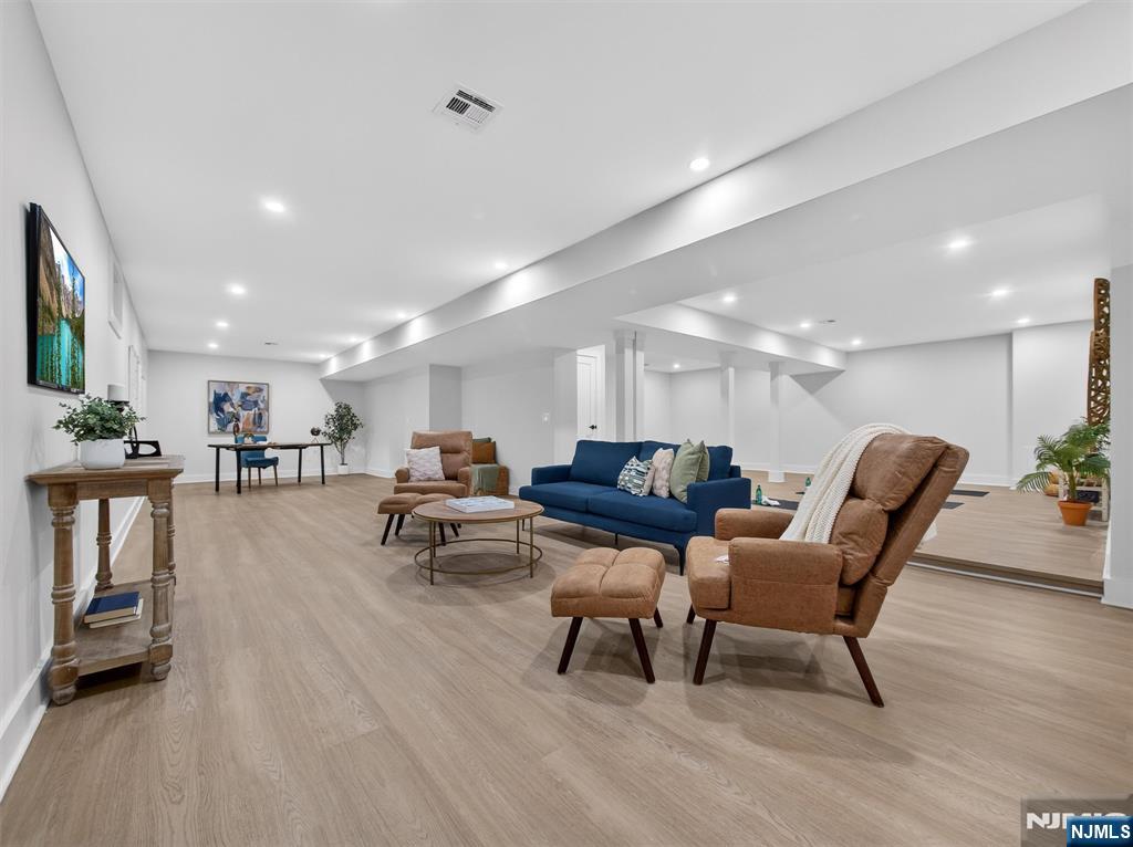 61 Beech Street Ramsey, NJ 07446 - Photo 34 of 41 a living room with furniture and a dining table with kitchen view