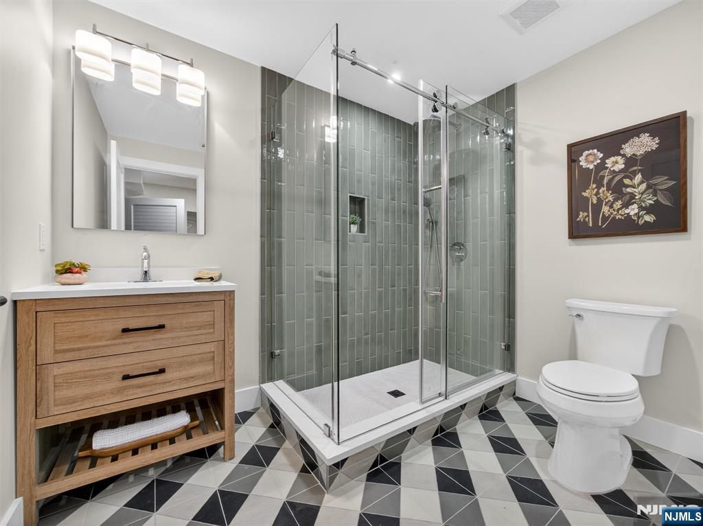 61 Beech Street Ramsey, NJ 07446 - Photo 37 of 41 a bathroom with a sink a toilet and shower