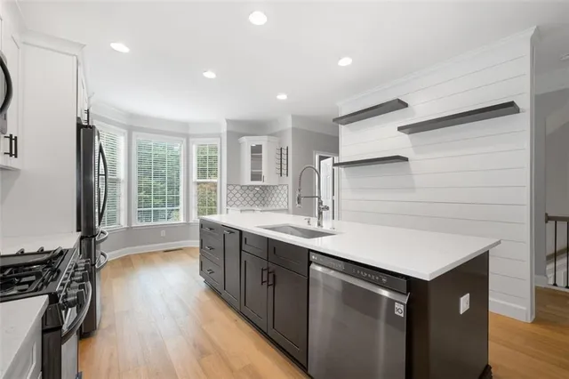a kitchen with a sink and wooden floor