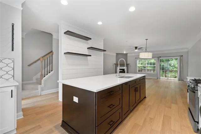 a kitchen with a stove a sink and a refrigerator
